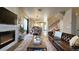 Open-concept living room with a fireplace, hardwood floors, and abundant natural light at 13640 Garfield St # A, Thornton, CO 80602