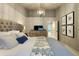 Beautiful bedroom with high ceilings, wainscoting, and a stylish dresser and wall decor at 13640 Garfield St # A, Thornton, CO 80602