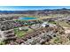 Expansive aerial view of a residential area with a scenic lake and mountain backdrop, offering a serene living environment at 5822 S Van Gordon Ln, Littleton, CO 80127