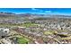 Expansive aerial shot of a residential community nestled among green spaces and rolling hills at 5822 S Van Gordon Ln, Littleton, CO 80127