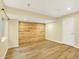 Spacious basement bedroom features luxury vinyl plank flooring, and a shiplap accent wall at 5822 S Van Gordon Ln, Littleton, CO 80127