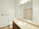 Traditional bathroom featuring a single sink vanity, tile floor and large mirror at 5822 S Van Gordon Ln, Littleton, CO 80127