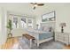 Bedroom with natural light, neutral walls and a large bed with a patterned rug underneath at 5822 S Van Gordon Ln, Littleton, CO 80127
