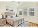Bedroom featuring a plush bed with decorative pillows, and natural light from the windows at 5822 S Van Gordon Ln, Littleton, CO 80127