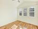 Bright bedroom featuring light-colored walls, hardwood floors, and large windows offering ample natural light at 5822 S Van Gordon Ln, Littleton, CO 80127
