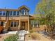 Charming townhome exterior featuring a front door, green accents, and well-manicured landscaping at 5822 S Van Gordon Ln, Littleton, CO 80127
