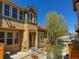 Exterior of a well-maintained townhome with a front entrance, complemented by a mature tree at 5822 S Van Gordon Ln, Littleton, CO 80127