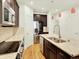 Bright kitchen boasts stainless steel appliances, a spacious island, and dark cabinets, perfect for culinary enthusiasts at 5822 S Van Gordon Ln, Littleton, CO 80127