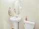 Clean powder room with pedestal sink, oval mirror, and elongated toilet at 5822 S Van Gordon Ln, Littleton, CO 80127