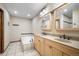 Bathroom with a tub, double sink vanity, and neutral tile flooring at 510 Silhouette Way, Monument, CO 80132