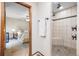 Modern bathroom featuring tiled walk-in shower with built in seat, and views into the bedroom at 510 Silhouette Way, Monument, CO 80132