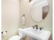 Simple bathroom features pedestal sink, round mirror and toilet at 510 Silhouette Way, Monument, CO 80132