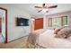 Inviting bedroom featuring a mounted TV, closet, and a view through the window at 510 Silhouette Way, Monument, CO 80132