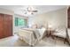 Comfortable bedroom with a ceiling fan, large window, and closet at 510 Silhouette Way, Monument, CO 80132