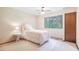 Neutral bedroom design with large window overlooking treed backyard and closet at 510 Silhouette Way, Monument, CO 80132