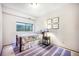 Bright bedroom with a cozy quilt, bedside table, and natural light at 510 Silhouette Way, Monument, CO 80132