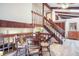 Cozy dining area with wooden table, chairs, beams, staircase and bright natural light at 510 Silhouette Way, Monument, CO 80132