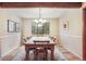 Cozy dining area with a large window and rustic wooden table with seating for six at 510 Silhouette Way, Monument, CO 80132