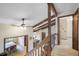 Open hallway with wood beams, overlooks dining room and kitchen at 510 Silhouette Way, Monument, CO 80132