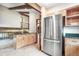 Bright kitchen featuring stainless steel refrigerator, wooden cabinets, and granite countertops at 510 Silhouette Way, Monument, CO 80132