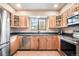 Bright kitchen with wooden cabinets, stainless appliances, and natural light at 510 Silhouette Way, Monument, CO 80132