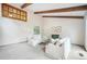 Bright living room featuring exposed beams, neutral decor, and ample natural light at 510 Silhouette Way, Monument, CO 80132