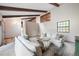 Comfortable living room with wood beams, neutral tones, and large windows at 510 Silhouette Way, Monument, CO 80132