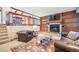 Basement living room features built in shelves, fireplace and leather seating at 510 Silhouette Way, Monument, CO 80132