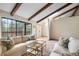 Relaxing living room with access to the deck and wood beam details at 510 Silhouette Way, Monument, CO 80132