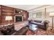 Basement living room features built in shelves, fireplace and leather seating at 510 Silhouette Way, Monument, CO 80132