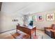 Bright office with vintage desk, area rug, and natural light from the window at 510 Silhouette Way, Monument, CO 80132