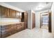 Pantry area with hardwood cabinets, tile floors, and a doorway at 510 Silhouette Way, Monument, CO 80132