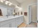 Stylish bathroom with double sinks, a large mirror, and a glass-enclosed shower at 6745 S Tempe Ct, Aurora, CO 80016