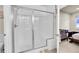 Bright bathroom with a modern shower featuring a glass door and a built-in bench at 6745 S Tempe Ct, Aurora, CO 80016