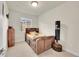 Cozy bedroom with a rustic wooden bed, dresser, and neutral carpet at 6745 S Tempe Ct, Aurora, CO 80016
