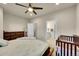 Bright bedroom with dark wooden furniture, a connecting door to the bathroom, and natural light at 6745 S Tempe Ct, Aurora, CO 80016