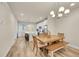 Open-concept dining area featuring wood-look floors and a modern chandelier at 6745 S Tempe Ct, Aurora, CO 80016