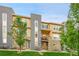 Stylish multi-level condo featuring stone accents, modern gray accents, and a charming balcony at 6745 S Tempe Ct, Aurora, CO 80016