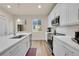 Bright kitchen featuring stainless steel appliances, white cabinets, and wood-look flooring at 6745 S Tempe Ct, Aurora, CO 80016