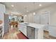 Bright kitchen featuring stainless steel appliances, white cabinets, and wood-look flooring at 6745 S Tempe Ct, Aurora, CO 80016