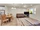 Open-concept living and dining area featuring wood-look floors and lots of natural light at 6745 S Tempe Ct, Aurora, CO 80016