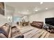 Spacious open-concept living area featuring wood-look floors and lots of natural light at 6745 S Tempe Ct, Aurora, CO 80016
