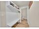 Hallway mudroom features a shiplap wall with a built-in bench and storage cubbies at 6745 S Tempe Ct, Aurora, CO 80016