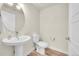 Modern half bathroom featuring a pedestal sink, stylish fixtures, and ample lighting at 6745 S Tempe Ct, Aurora, CO 80016
