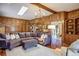 Comfortable living room with a plush sofa, wooden bookshelves, and natural light at 40 Charlou Cir, Cherry Hills Village, CO 80111