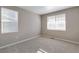 Bright bedroom with neutral carpet and two windows providing ample natural light at 13486 Valentia St, Thornton, CO 80602