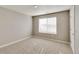 Bedroom featuring a window with blinds, neutral carpet and paint, and white trim at 13486 Valentia St, Thornton, CO 80602