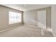 Bedroom featuring a window with blinds, neutral carpet and paint, and white trim at 13486 Valentia St, Thornton, CO 80602
