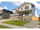 Attractive two-story home with a three-car garage, and inviting front yard at 13486 Valentia St, Thornton, CO 80602