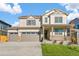 Charming two-story home featuring a three car garage and a welcoming front porch at 13486 Valentia St, Thornton, CO 80602